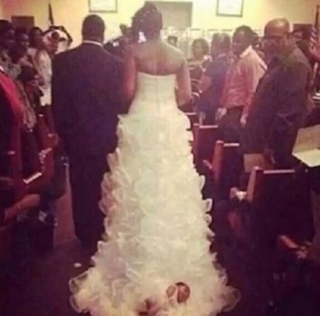 Baby Attached To The Train Of A Wedding Dress