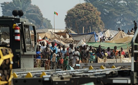 Refugees_of_the_fighting_in_the_Central_African_Republic_observe_Rwandan_soldiers_being_dropped_off_at_Bangui_M'Poko_International_Airport_in_the_Central_African_Republic - Public Domain