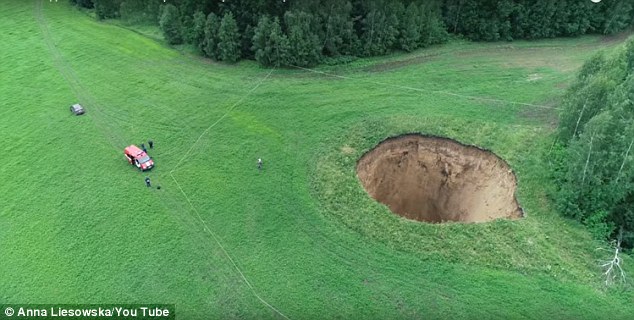 Russian Villagers Terrified As Foot Wide Sinkhole Deep Enough To Fit A Storey Building